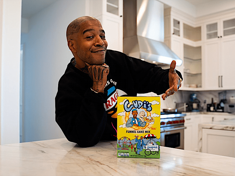 Kid Cudi posing with Limited-Edition Bisquick Funnel Cake Mix