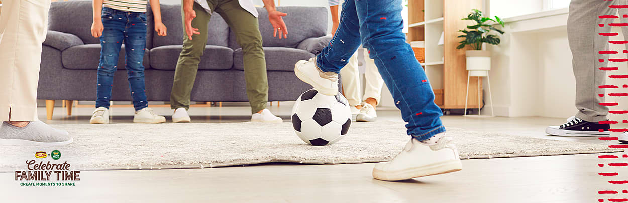 Kids playing soccer in the living room