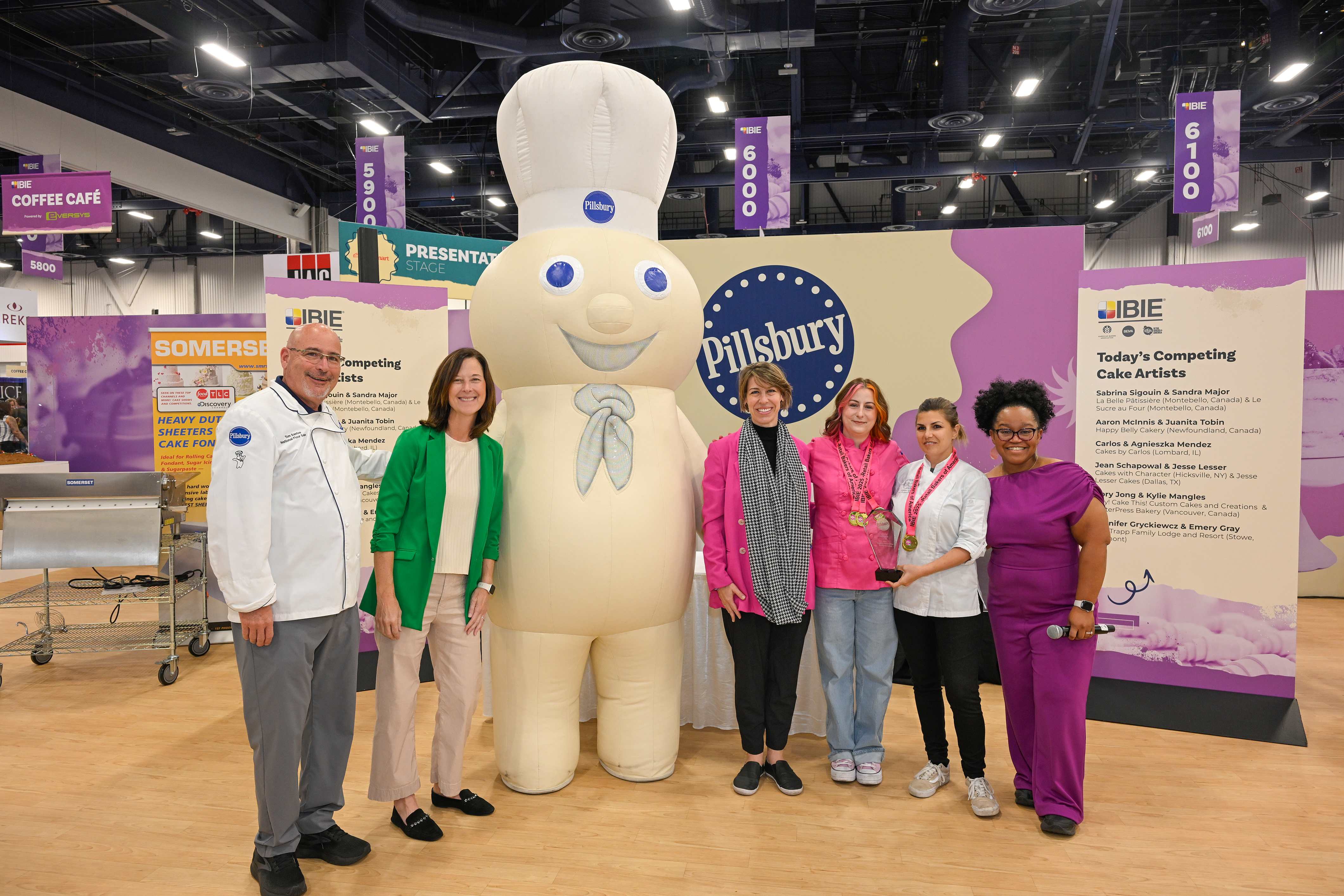 Team photo gathered near the Pillsbury Doughboy mascot