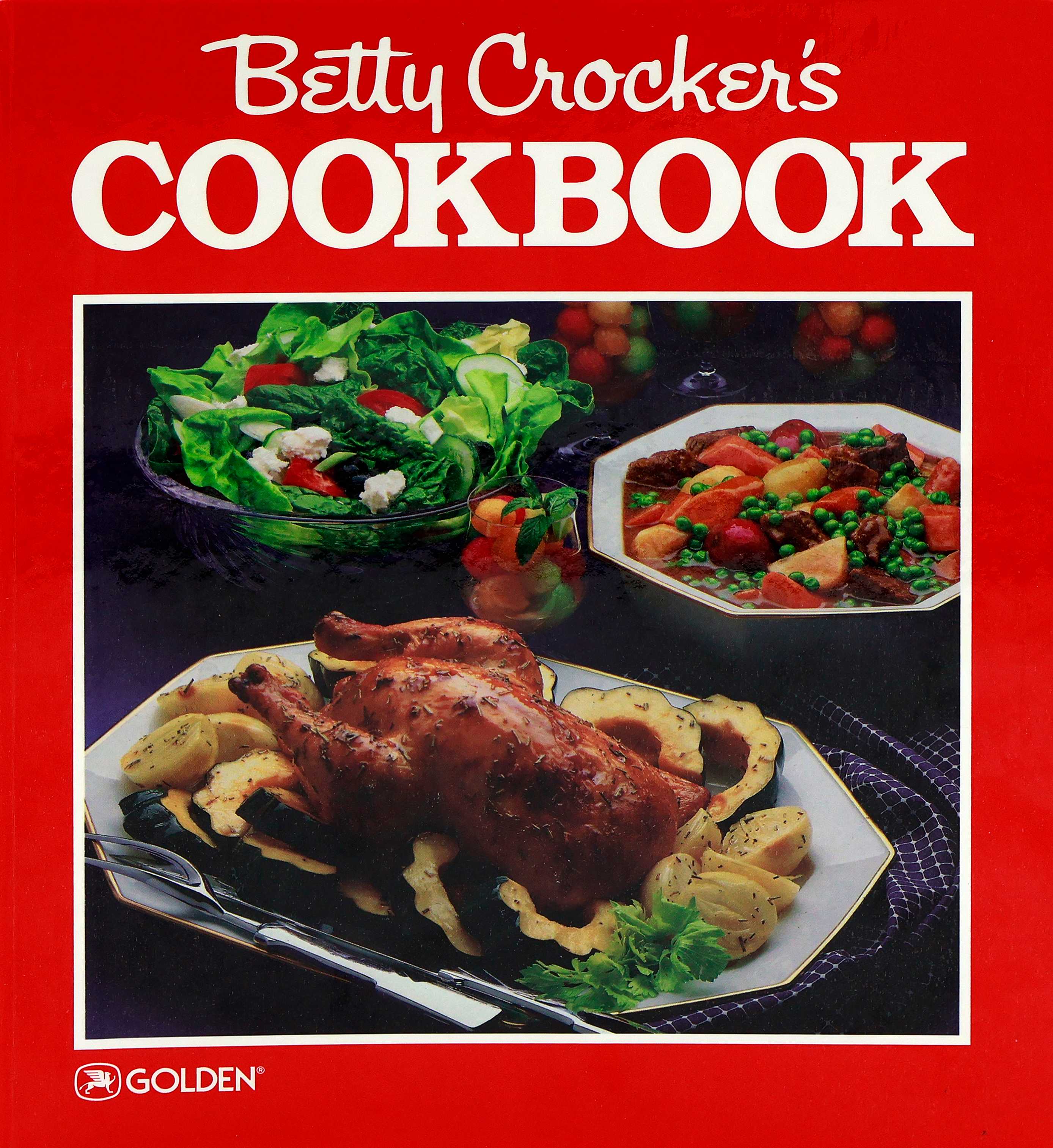 Cover of the 1986 Betty Crocker Cookbook with a red cover that has a roast chicken surrounded by acorn squash slices, tossed salad, beef stew, and melon balls in clear glass stemware.