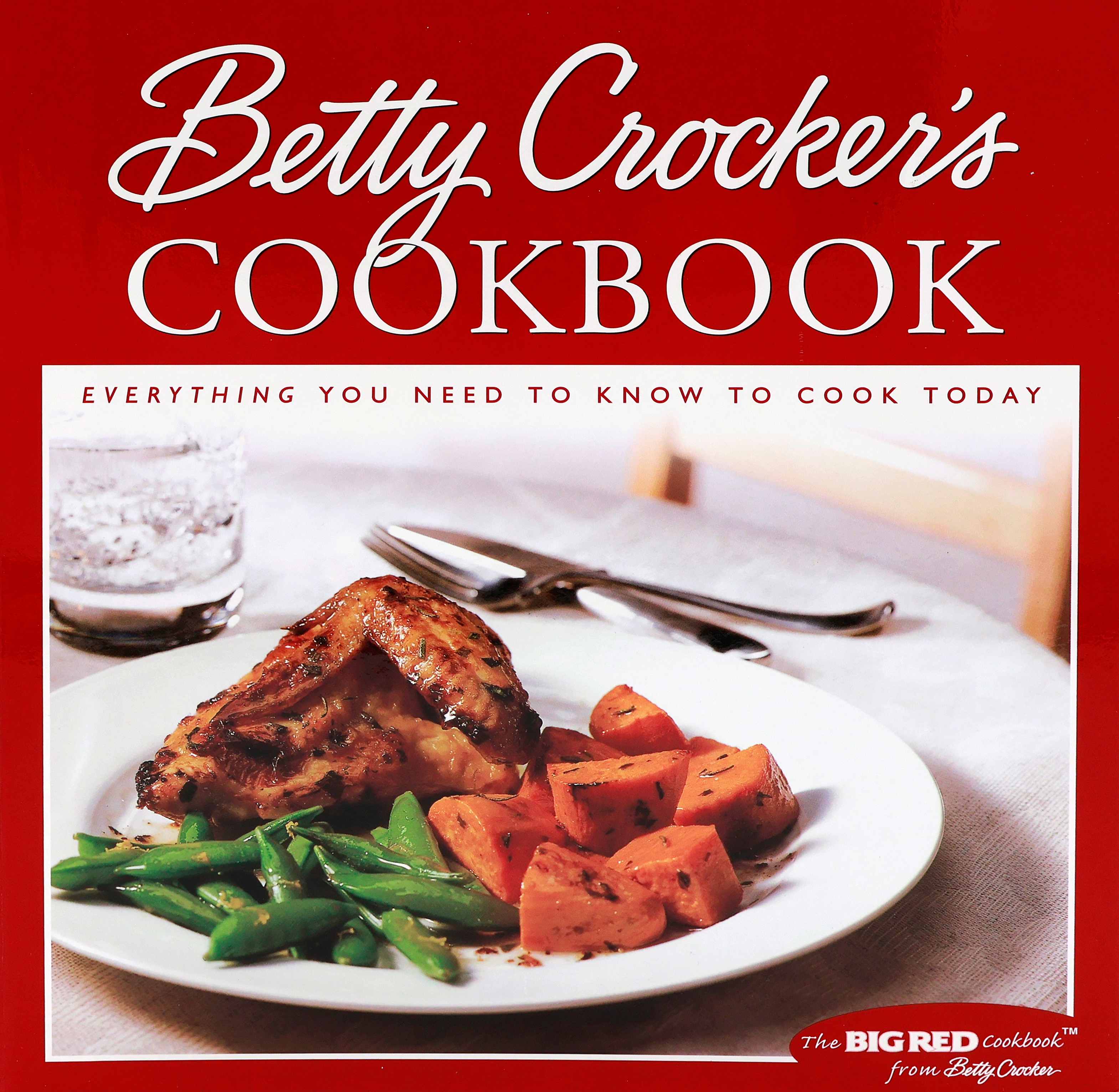 Cover of the 2000 Betty Crocker Cookbook with a red cover that has a large square on the front with the wording “Everything You Need to Know to Cook Today”.  The square has a white plate with a chicken fore section (breast half with wing), green peas in pods and chunks of sweet potatoes.  Says “the BIG RED Cookbook from Betty Crocker” in the lower right corner.