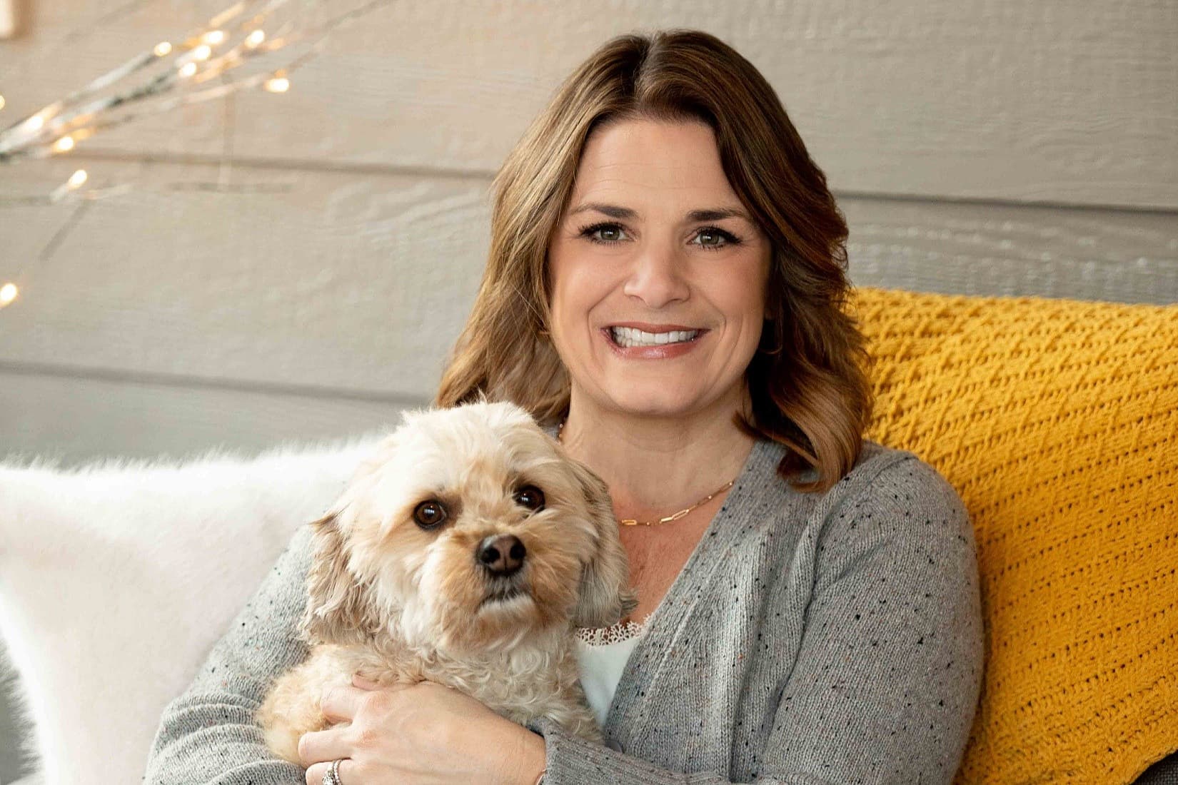 Bethany Quam, Group President, Pet sitting with her dog on her lap