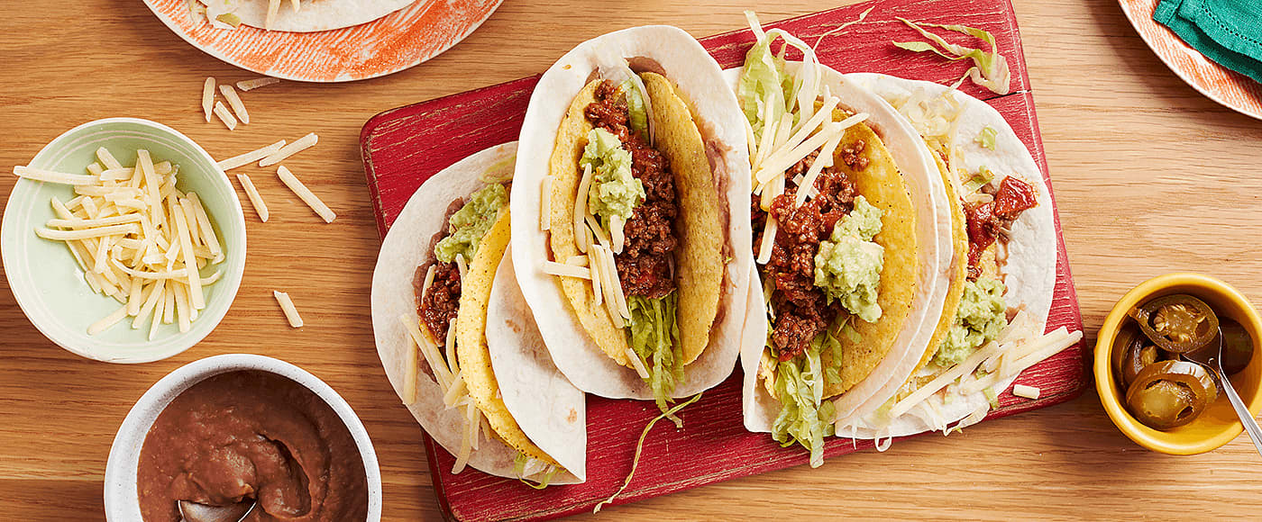 A double layered crunchy and soft taco with juicy beef and refried bean filling