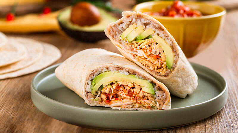 easy chicken burrito served on a gray plate on rustic wooden table
