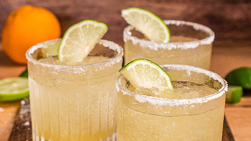Mexican margaritas in glasses, garnished with salt and lime