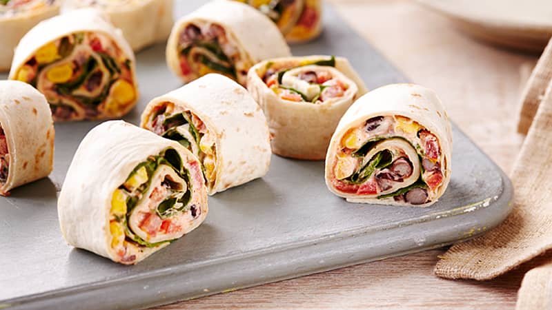 mexican vegetable rollups served on a gray plate