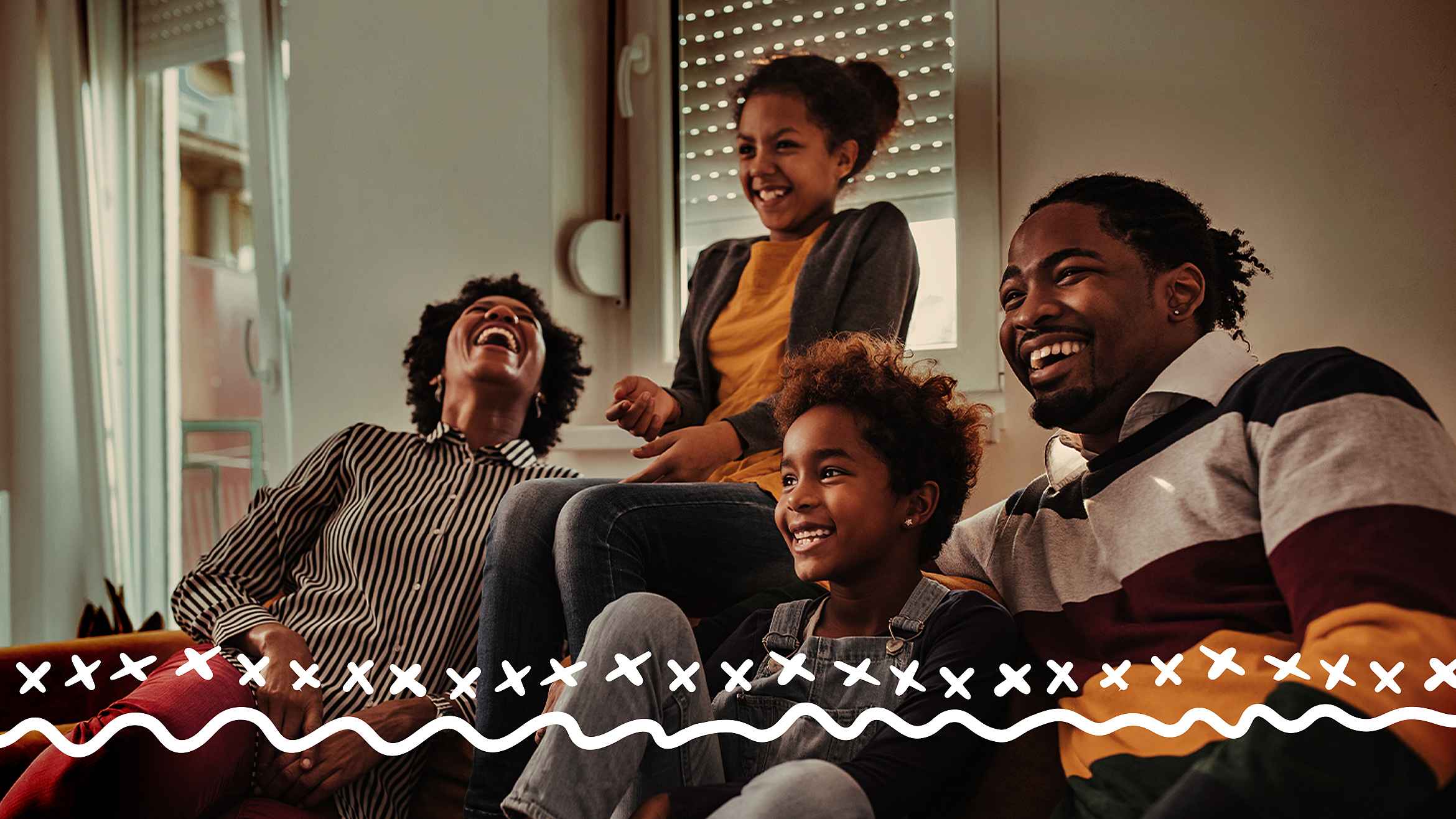 A group of four people laughing together