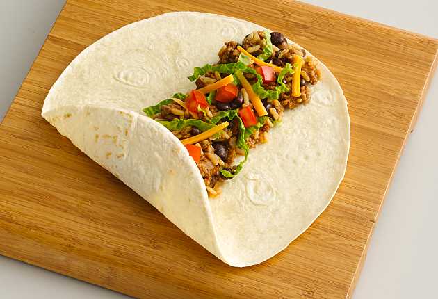 Center the ingredients on a burrito tortilla, fold up the bottom third of the tortilla
