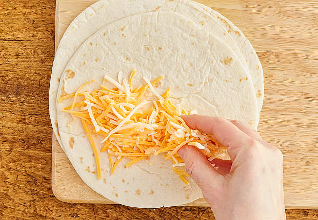 Shredded cheese on a tortilla