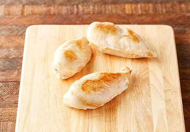 Cooked chicken breast on a cutting board