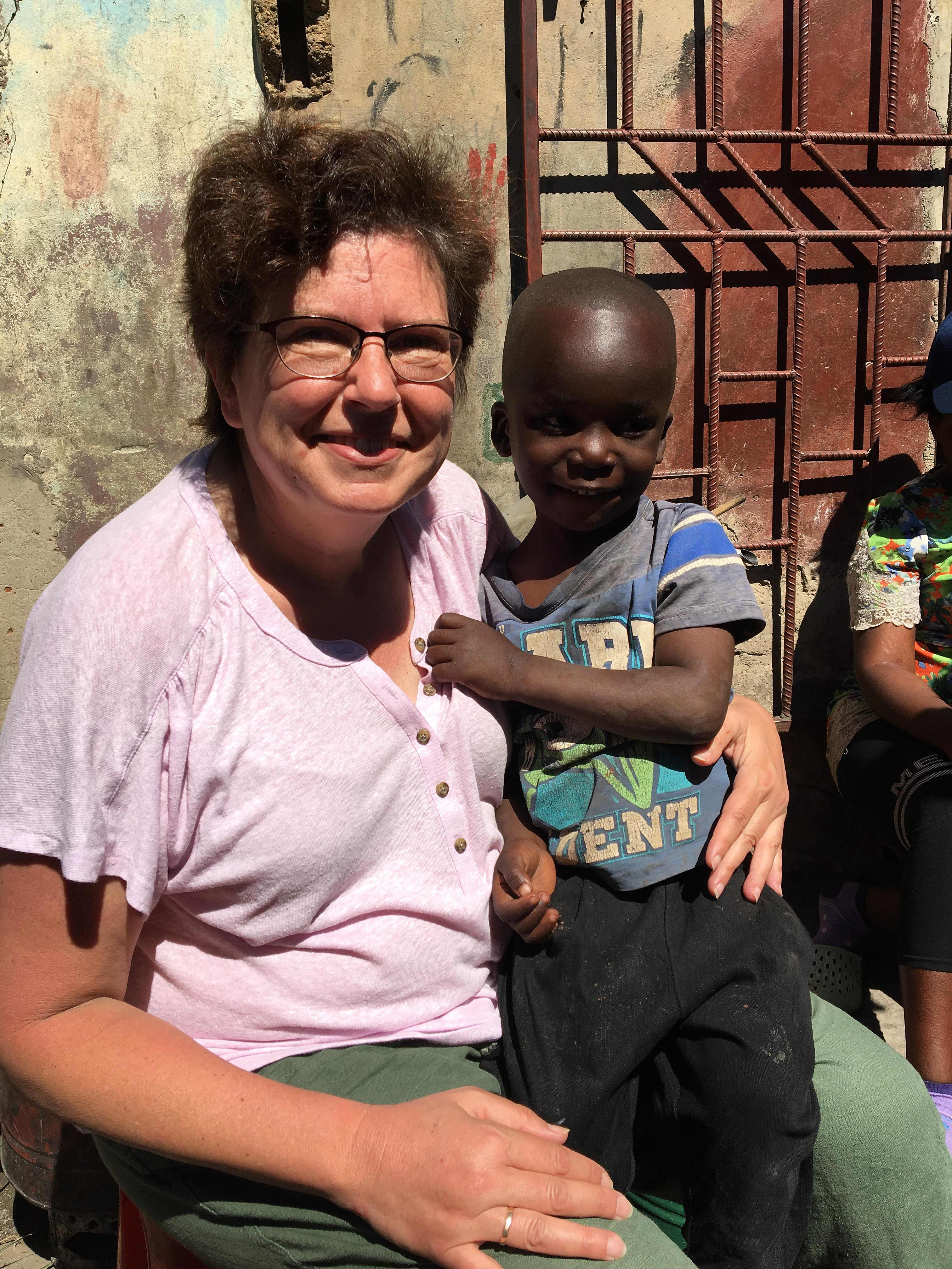 Michelle Meade with young boy in Africa
