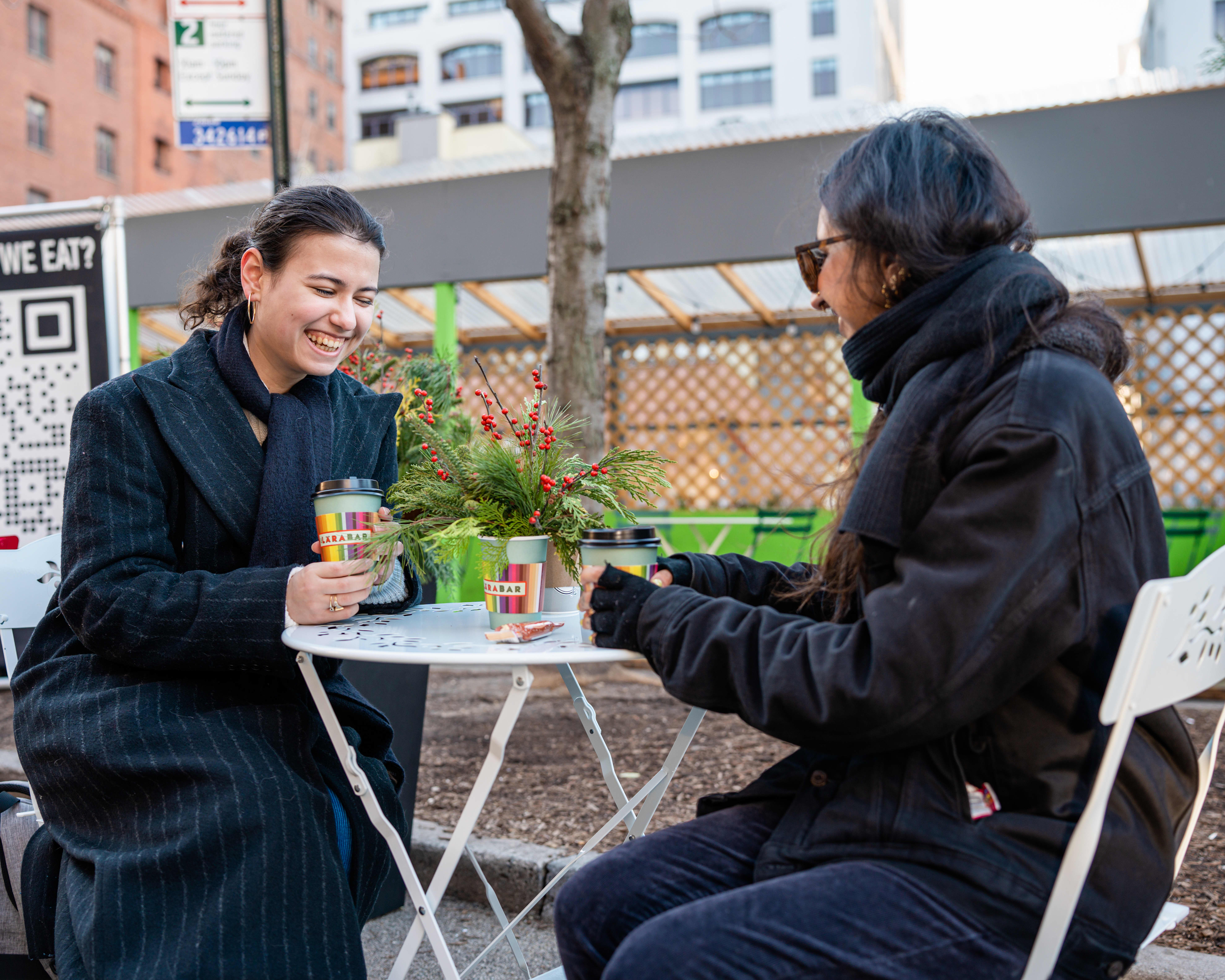 Two women enjoying coffee with their Larabars