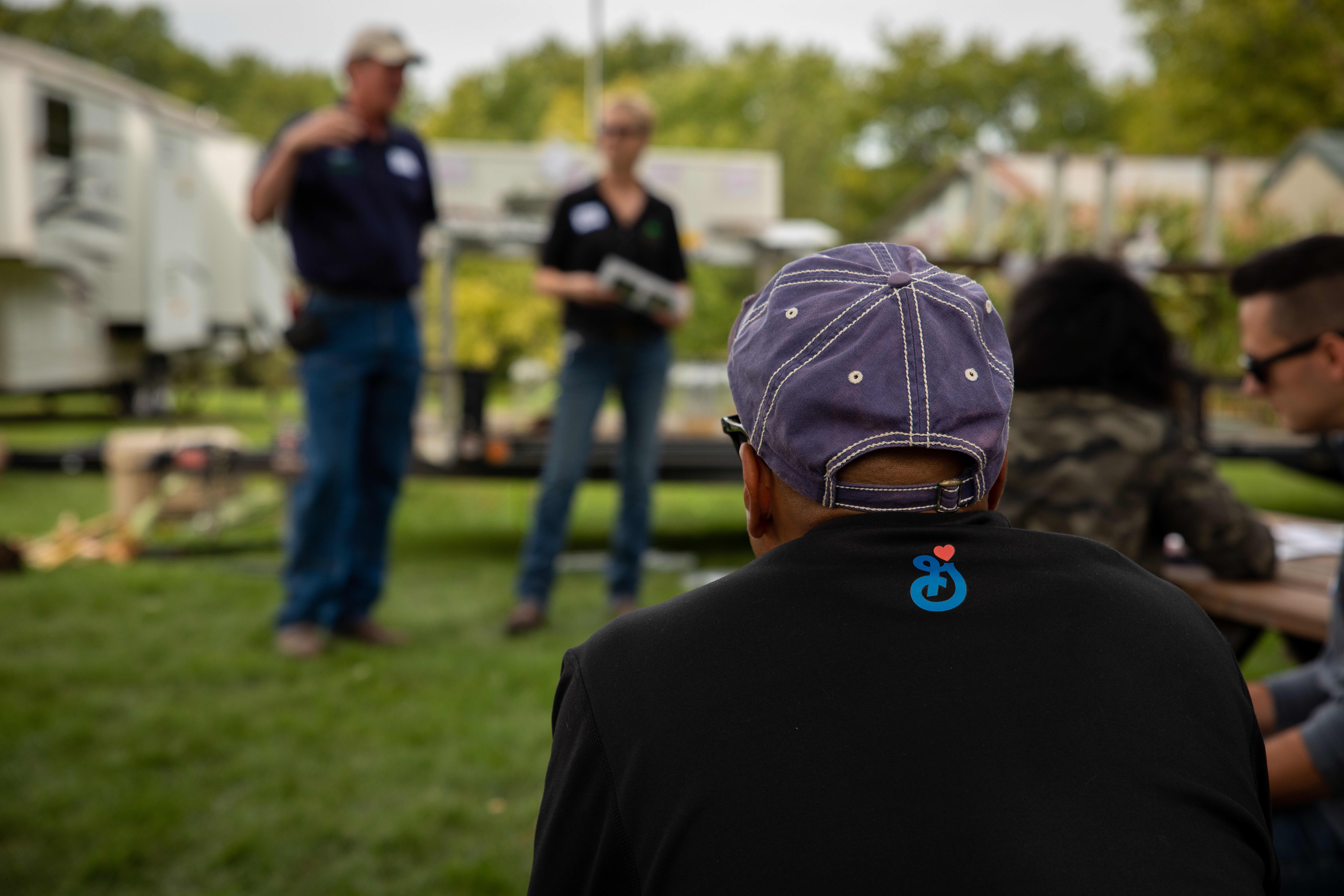 Employee listening to presentation with a General Mills logo on their shirt
