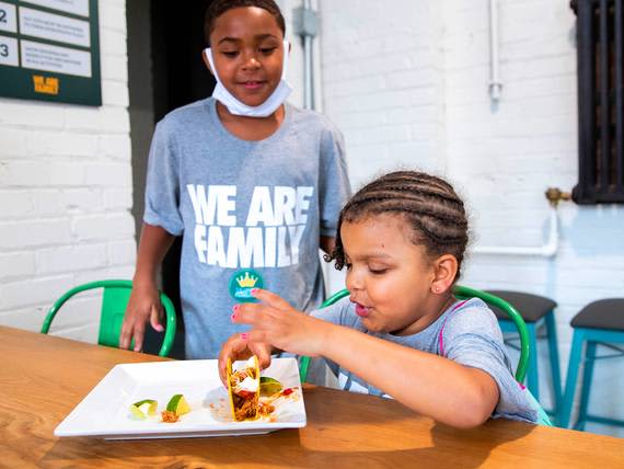 Two children enjoying Old El Paso Tacos together